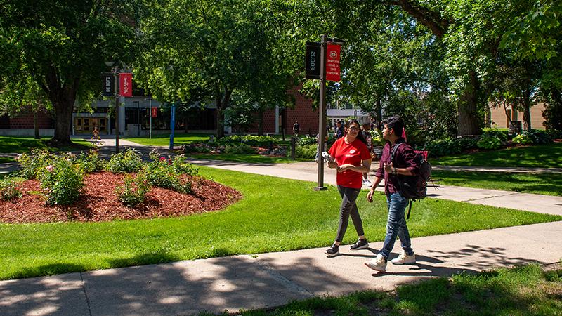 Students walking on campus sidewalk