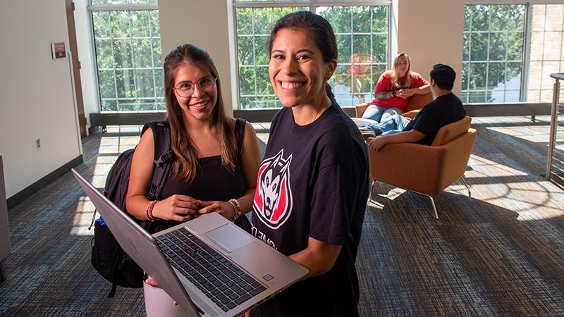 Two smiling with laptop