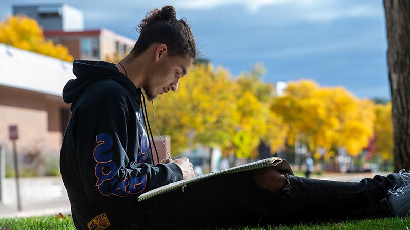 Student drawing outside