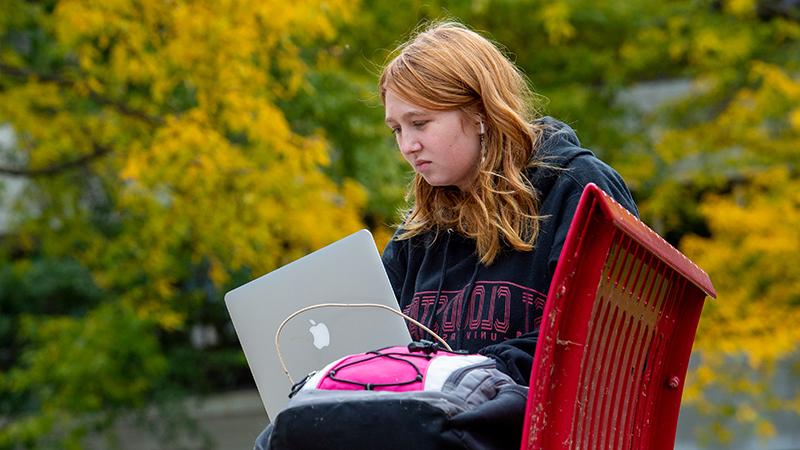 Student on laptop outside